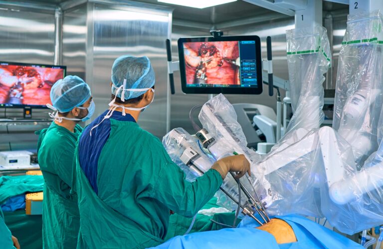 Surgeons perform surgery using surgical robotic device.